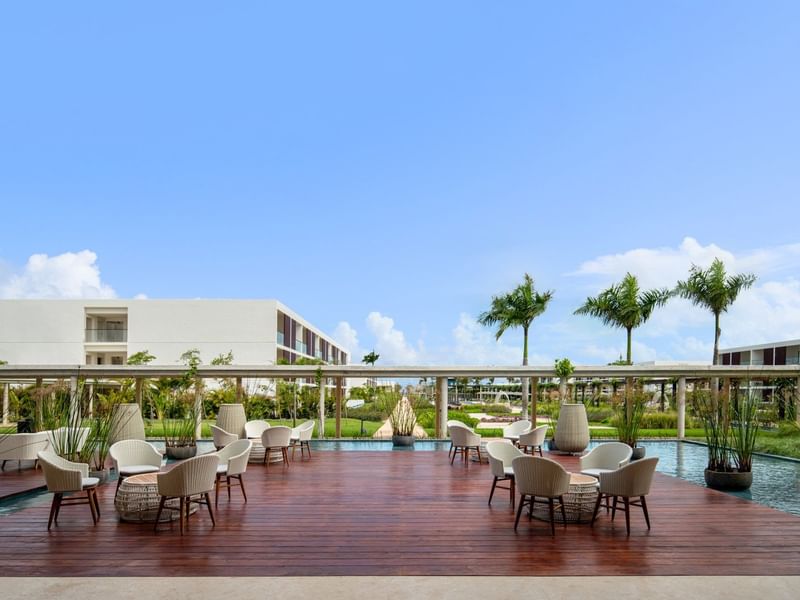 Terrace dining area by the pool at Live Aqua Resorts