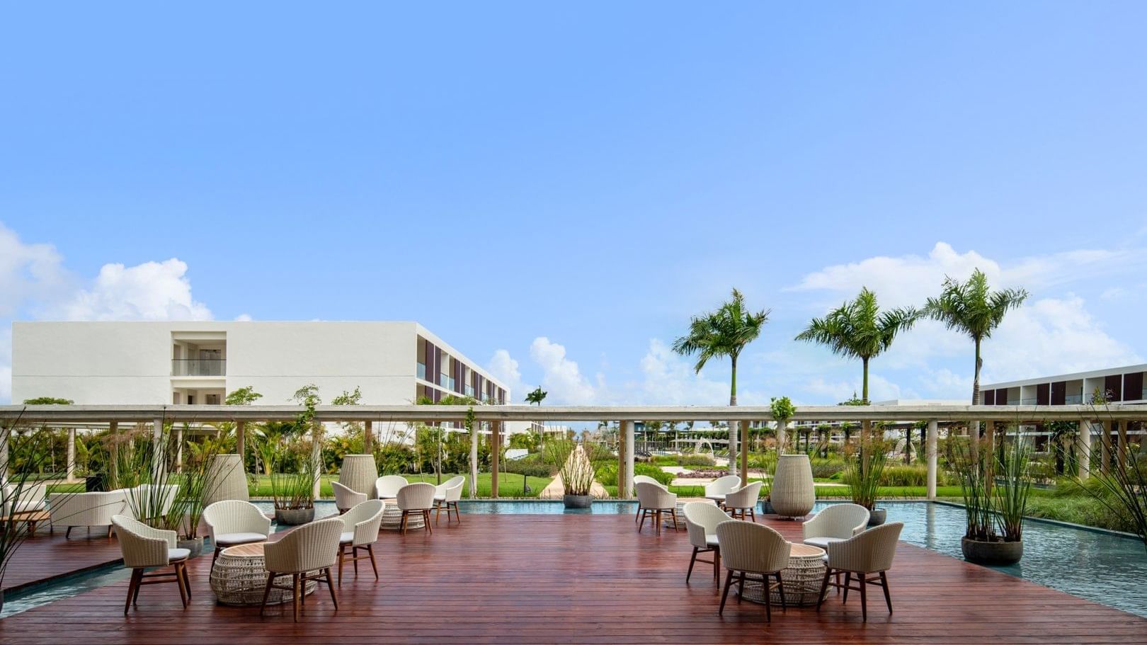Terrace dining area by the pool at Live Aqua Resorts