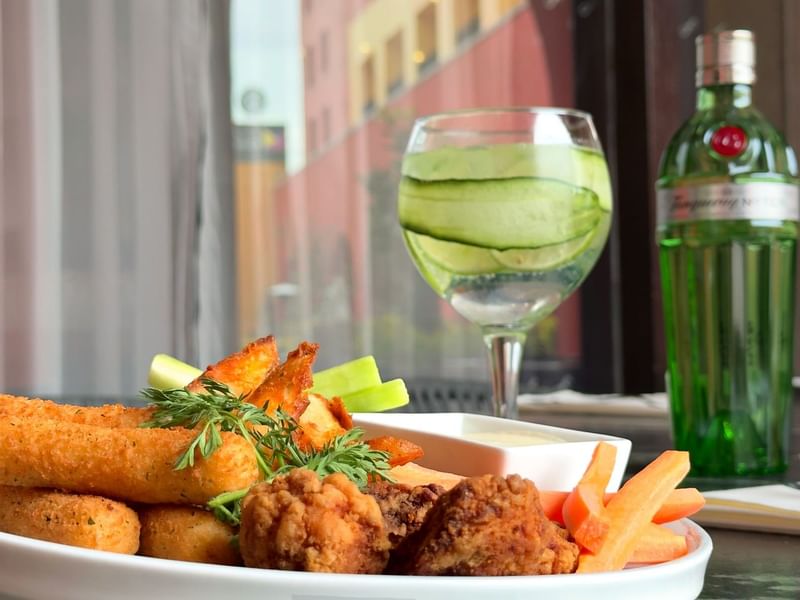 Fried snacks and a cocktail served in Stelaris Cocktail Lounge at Grand Fiesta Americana