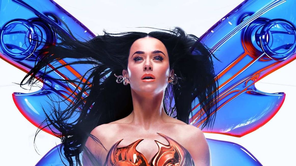 Katy Perry performing live on stage in a vibrant outfit with fireworks and neon lights in the background