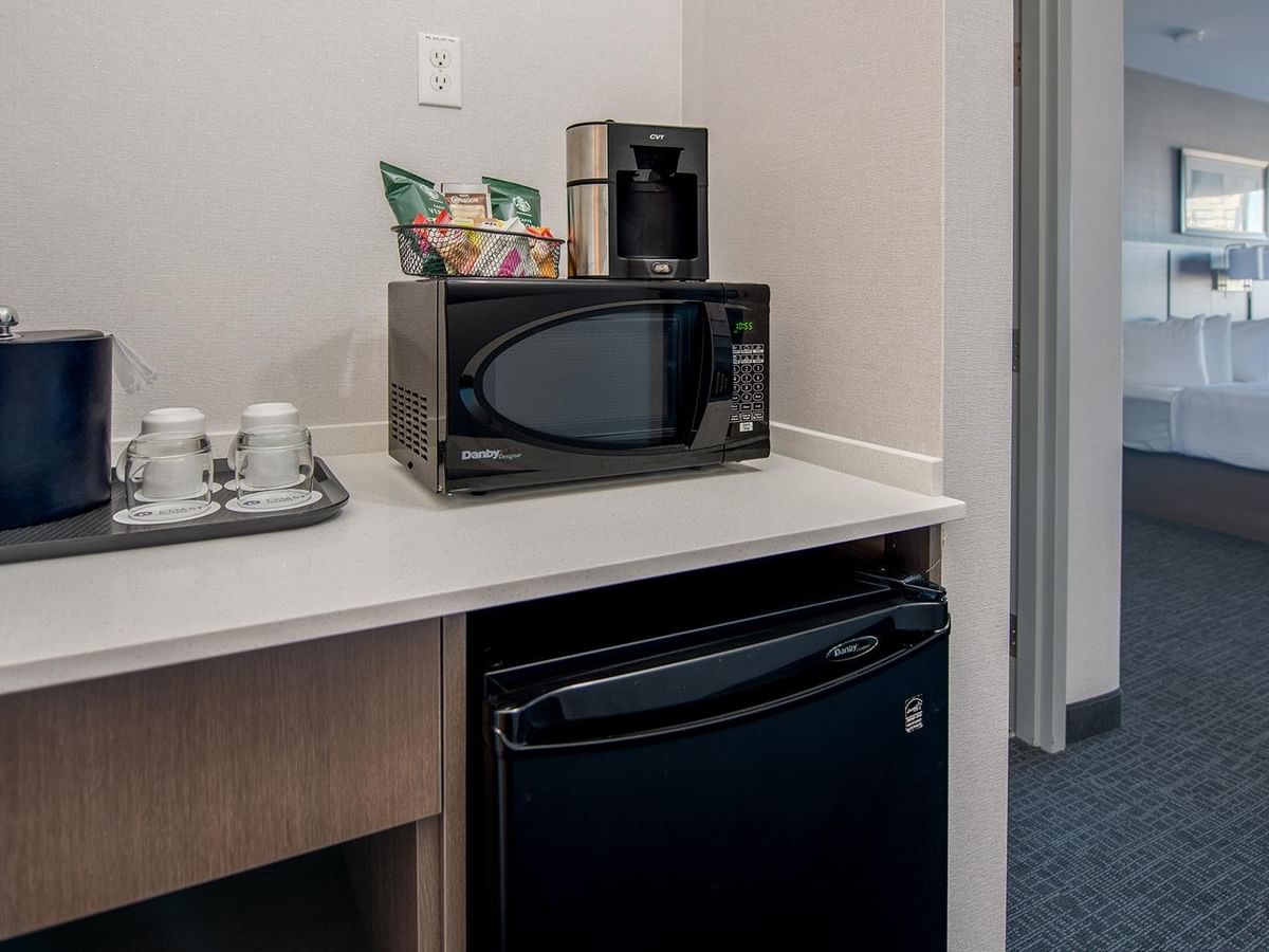 Microwave, coffee maker, and mini-fridge.