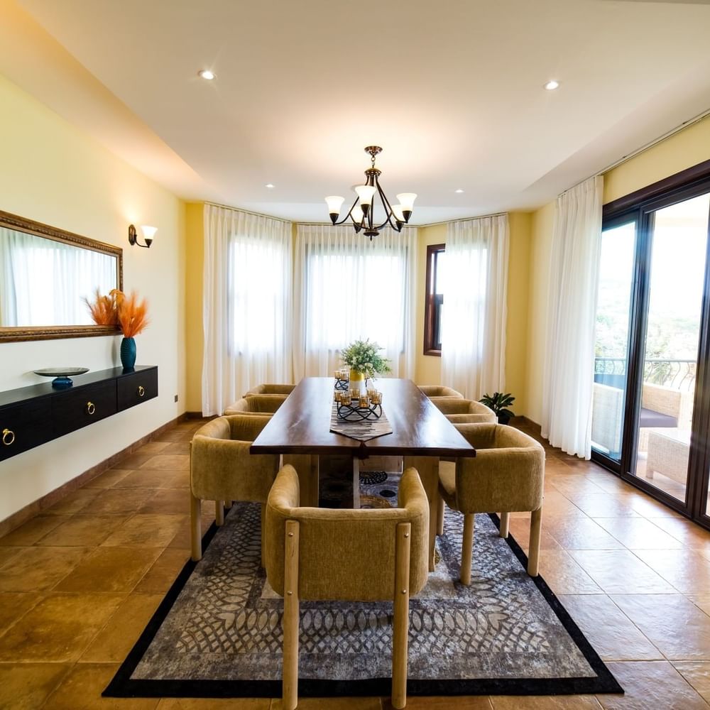 Elegant dining room with table and chairs at Lake Victoria Serena Golf Resort & Spa in Kampala.