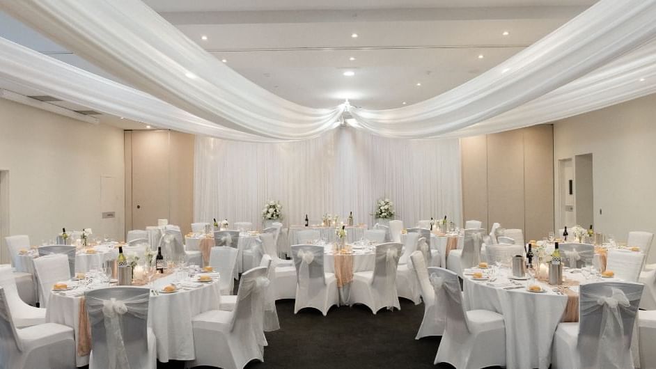 Elegant interior of a wedding reception area with table set up at Mercure Kooindah Waters
