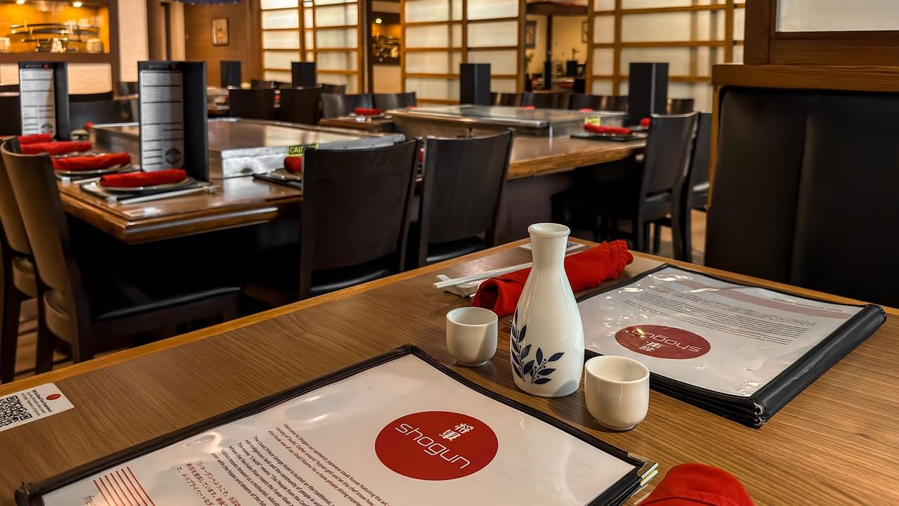 Restaurant with several tables, each set with a menu.