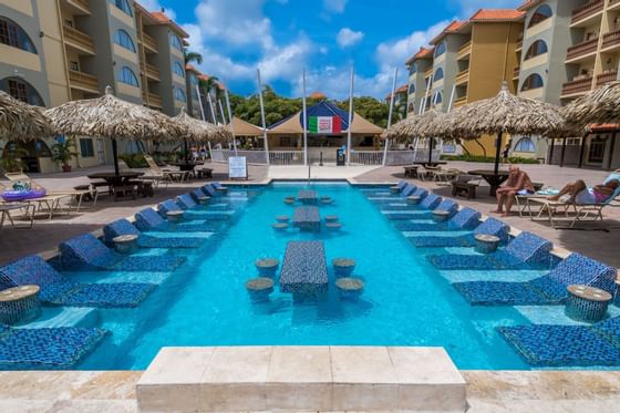 Lounge chairs in the outdoor pool at Eagle Aruba Resort
