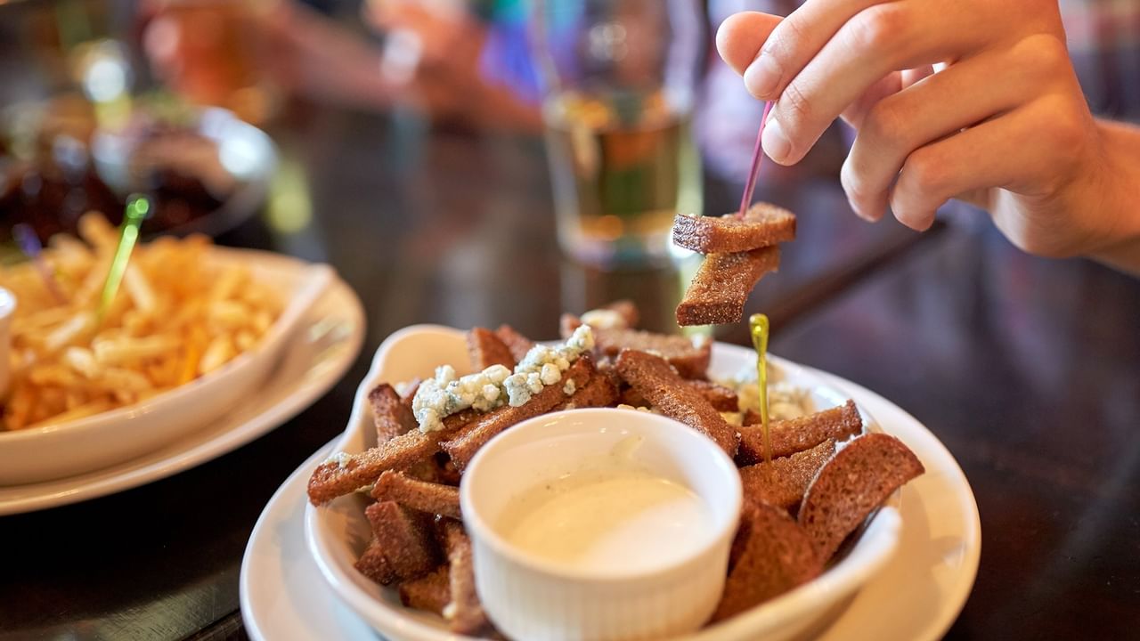 hand reaching ofr shared food a bar