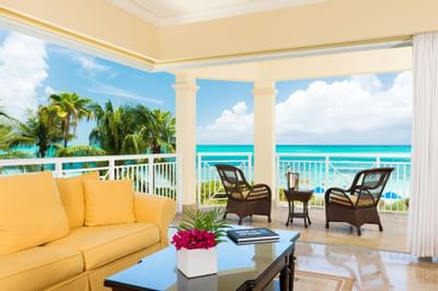 Living area with sofa and terrace with ocean view in 2 Bedroom Suite at Windsong Resort On The Reef