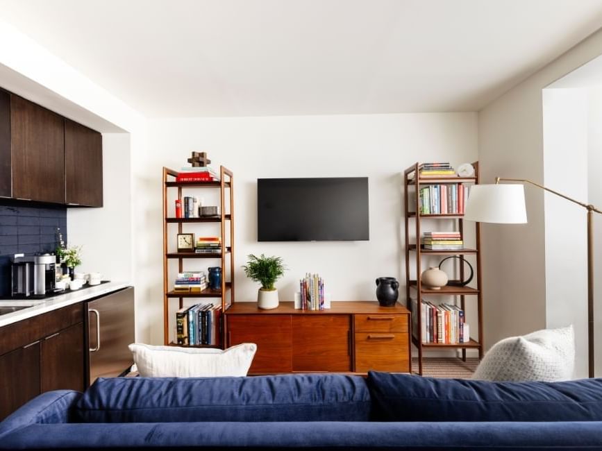 Cozy lounger, equipped kitchenette, shelves, and a TV in Executive Suite at The Study Hotel at Johns Hopkins