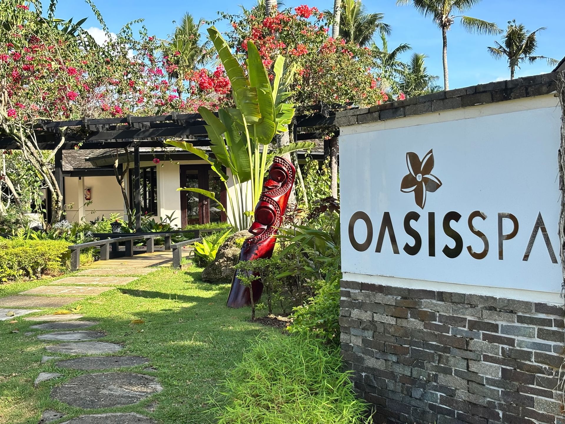 Oasis Spa sign by a pathway in a tropical garden at Warwick Le Lagon - Vanuatu Port Vila