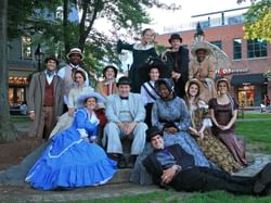 a group of people dressed up in historic clothing