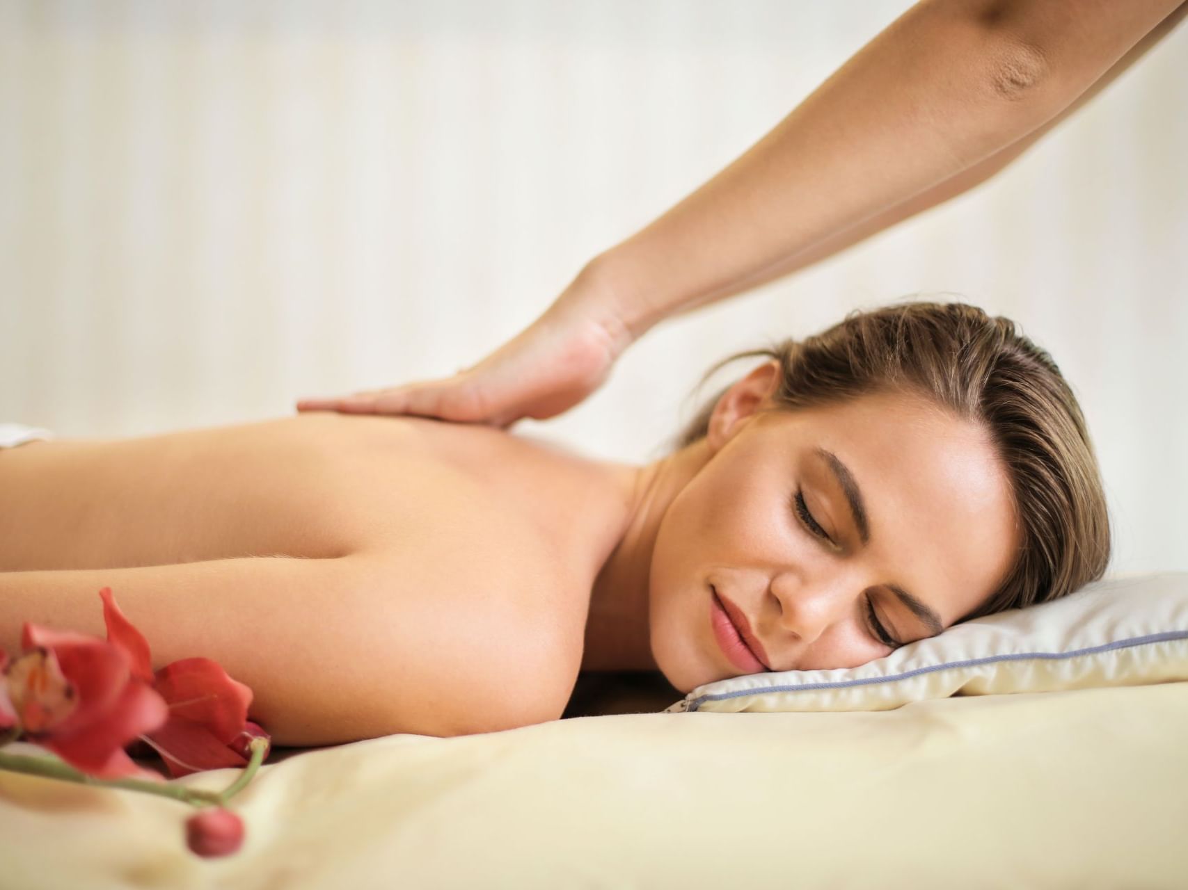 Woman getting a spa massage at Villas Sol Beach Resort