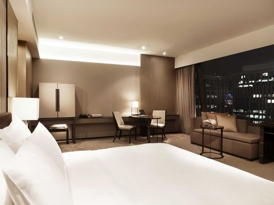 Premier Club Bedroom with king bed at Okura Prestige Hotel
