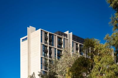 Exterior view of the hotel & trees at Nesuto Docklands