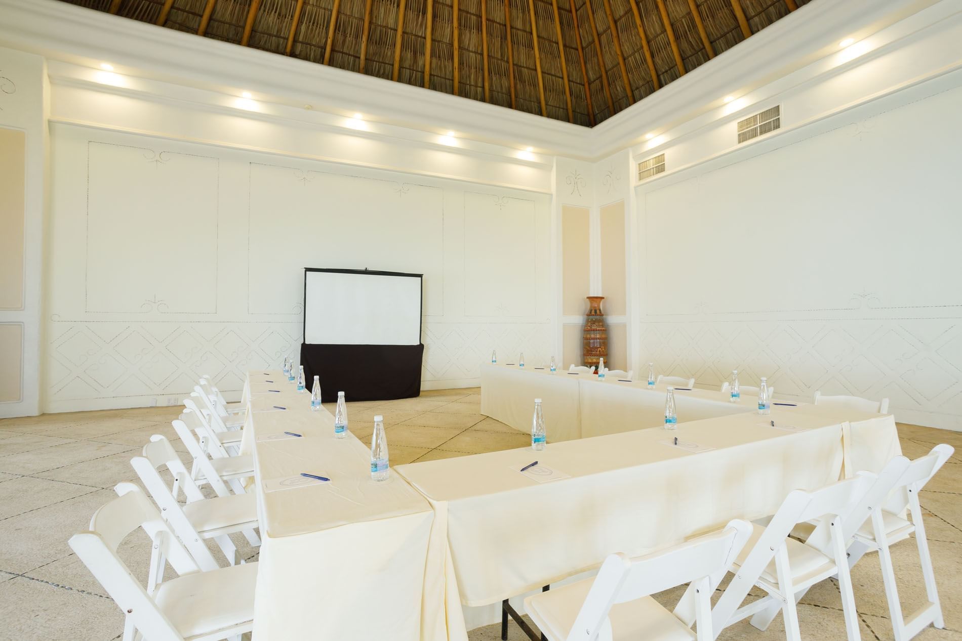 Spacious Ixtac Venue showing a U-shape table setup under a tall thatched ceiling at Quinta Real Acapulco
