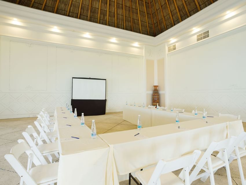 Spacious Ixtac Venue showing a U-shape table setup under a tall thatched ceiling at Quinta Real Acapulco