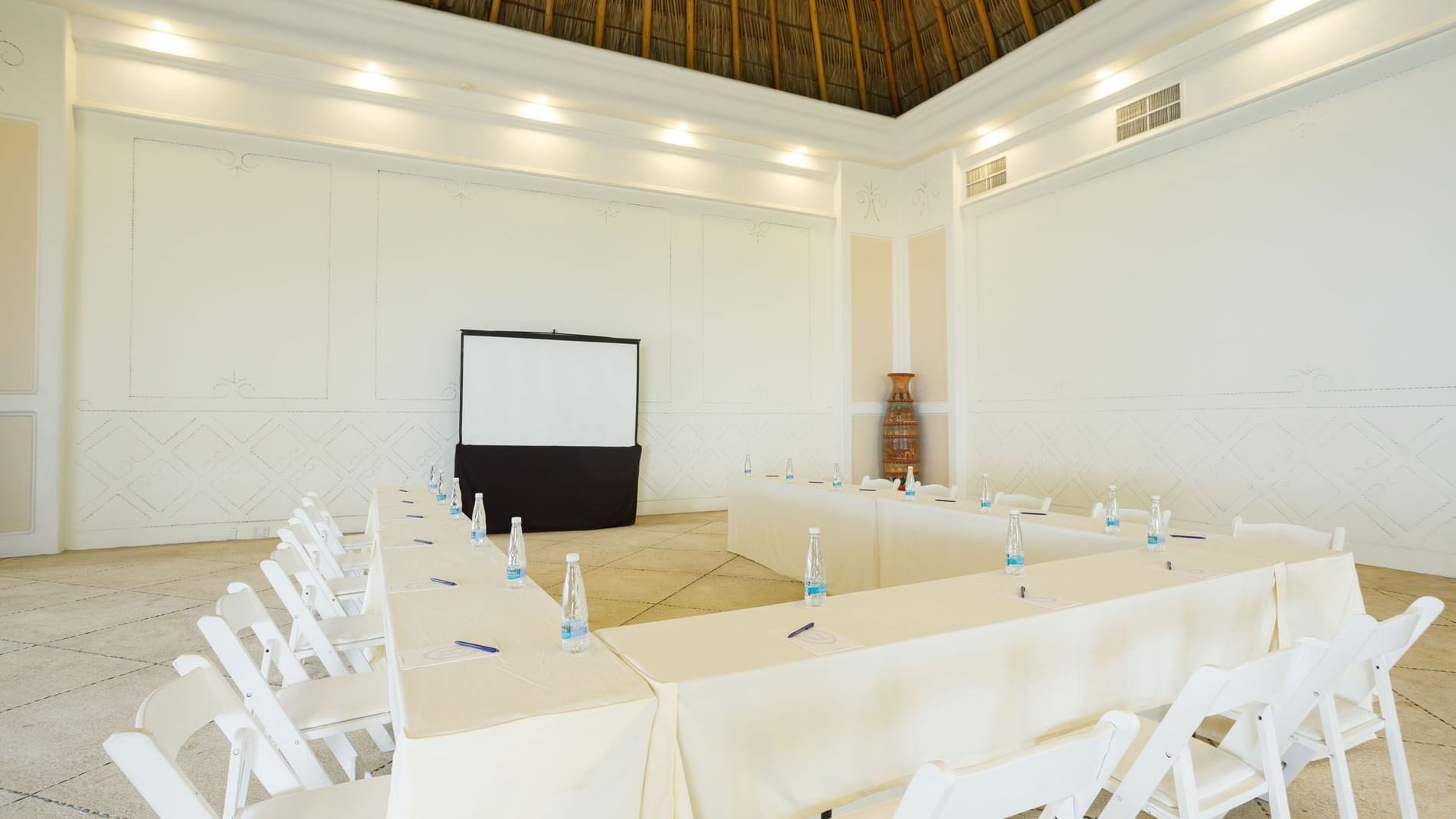 Spacious Ixtac Venue showing a U-shape table setup under a tall thatched ceiling at Quinta Real Acapulco