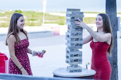 2 young ladies playing Jenga tower at Bilmar Beach Resort