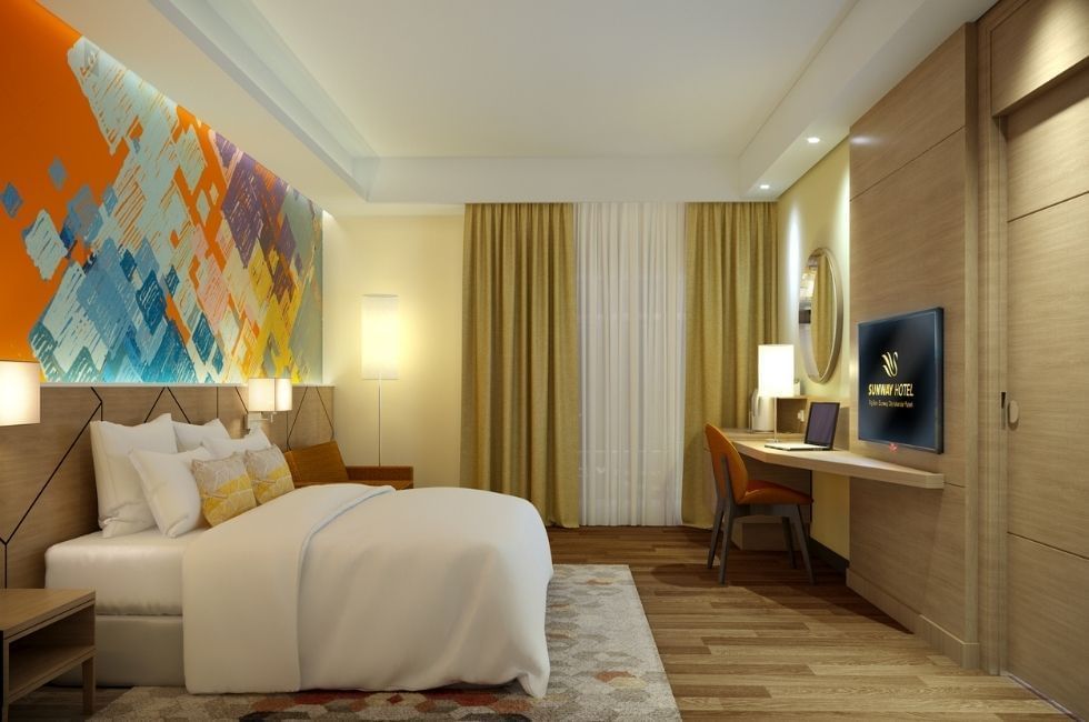 Deluxe Plus King Bedroom with an abstract art piece above the bed and work area at Sunway Hotel Big Box