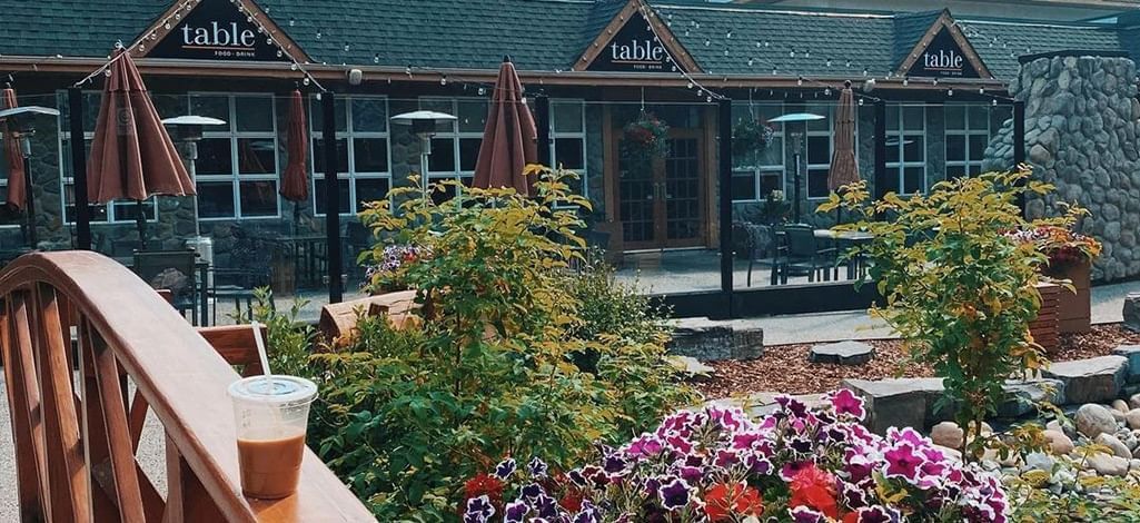 Cozy outdoor patio with flowers at Table Food + Drink restaurant