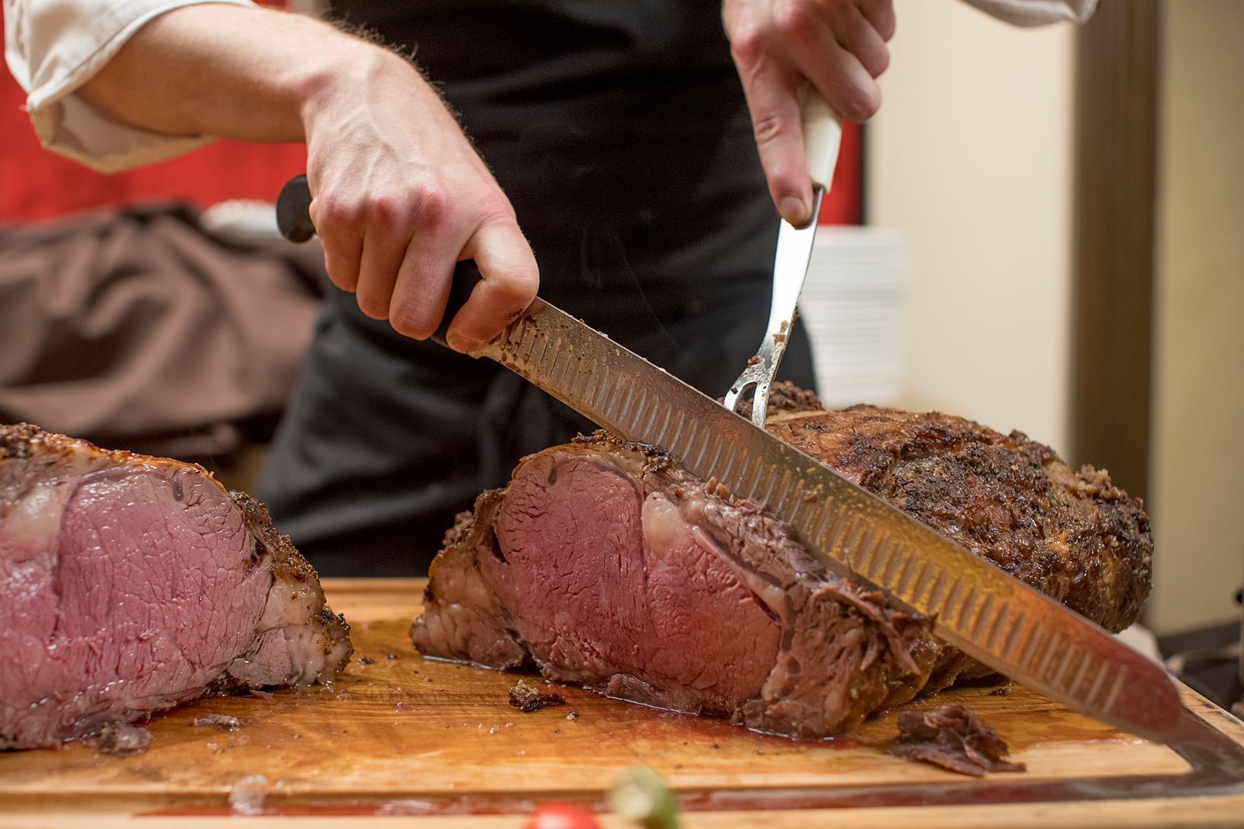 Closeup of chef cutting steak at The Peabody Memphis