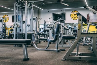 A fitness center with well-equipped machines and weights at Irazu Hotel