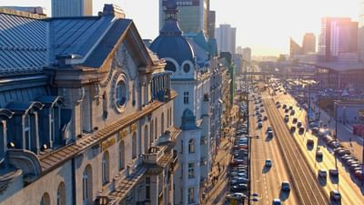 Sunset view over a busy city street filled with cars near Polonia Palace Hotel