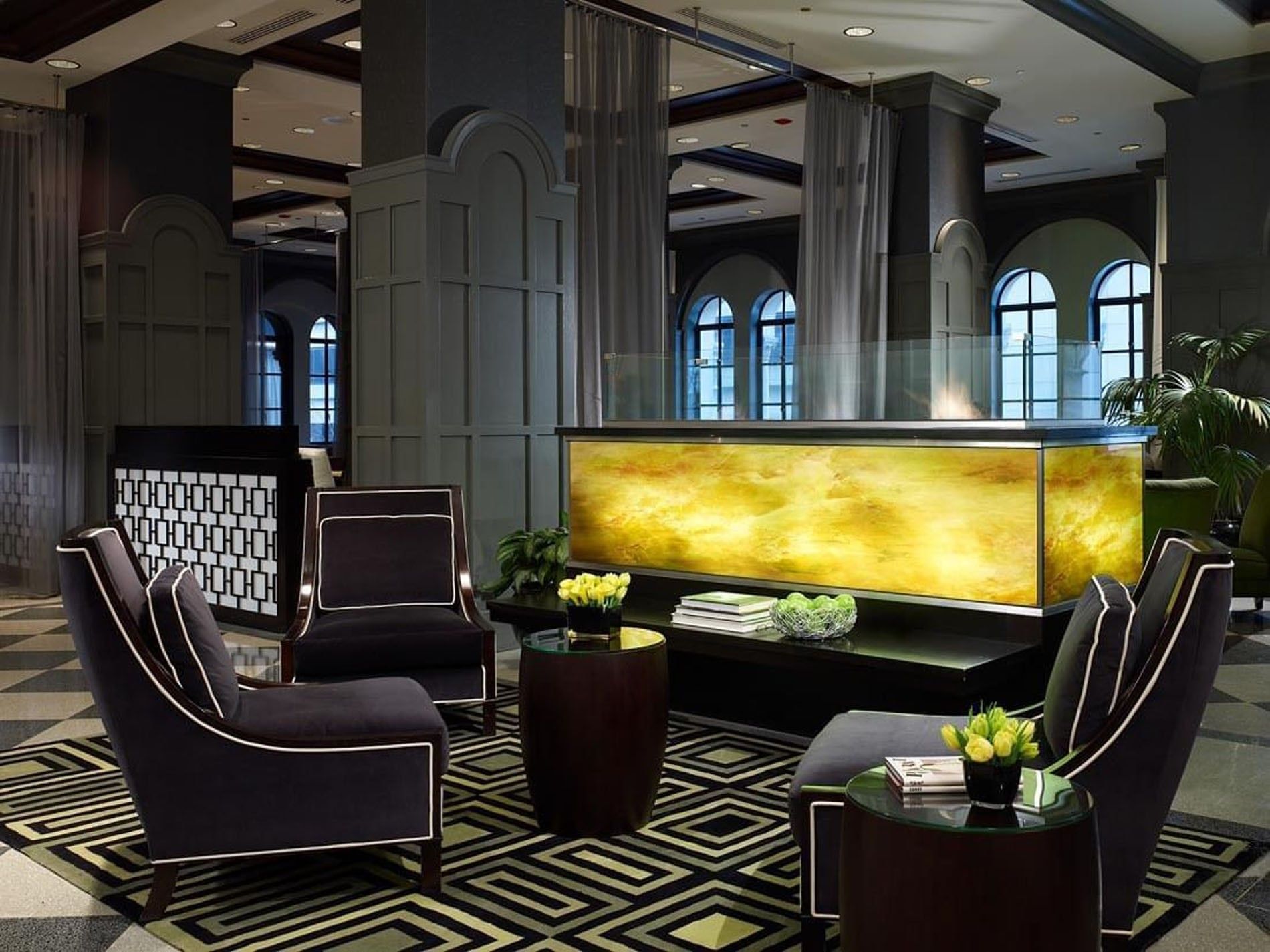 Lounge area with chairs and a geometric-patterned carpet at Warwick Allerton Chicago
