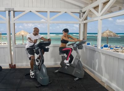 Couple on exercycles in the gym at Holiday Inn Montego Bay