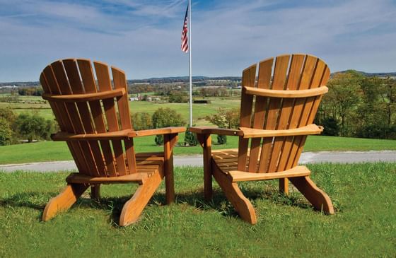 Adirondack chairs beside a flagpole.
