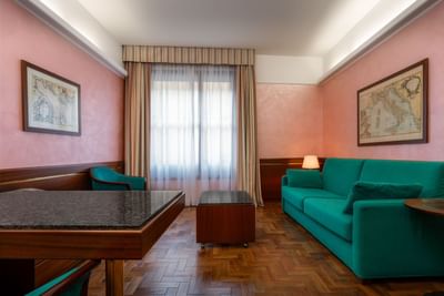 Comfy sofa and table with chairs in Executive Suite at Hotel Crivi's in Milan
