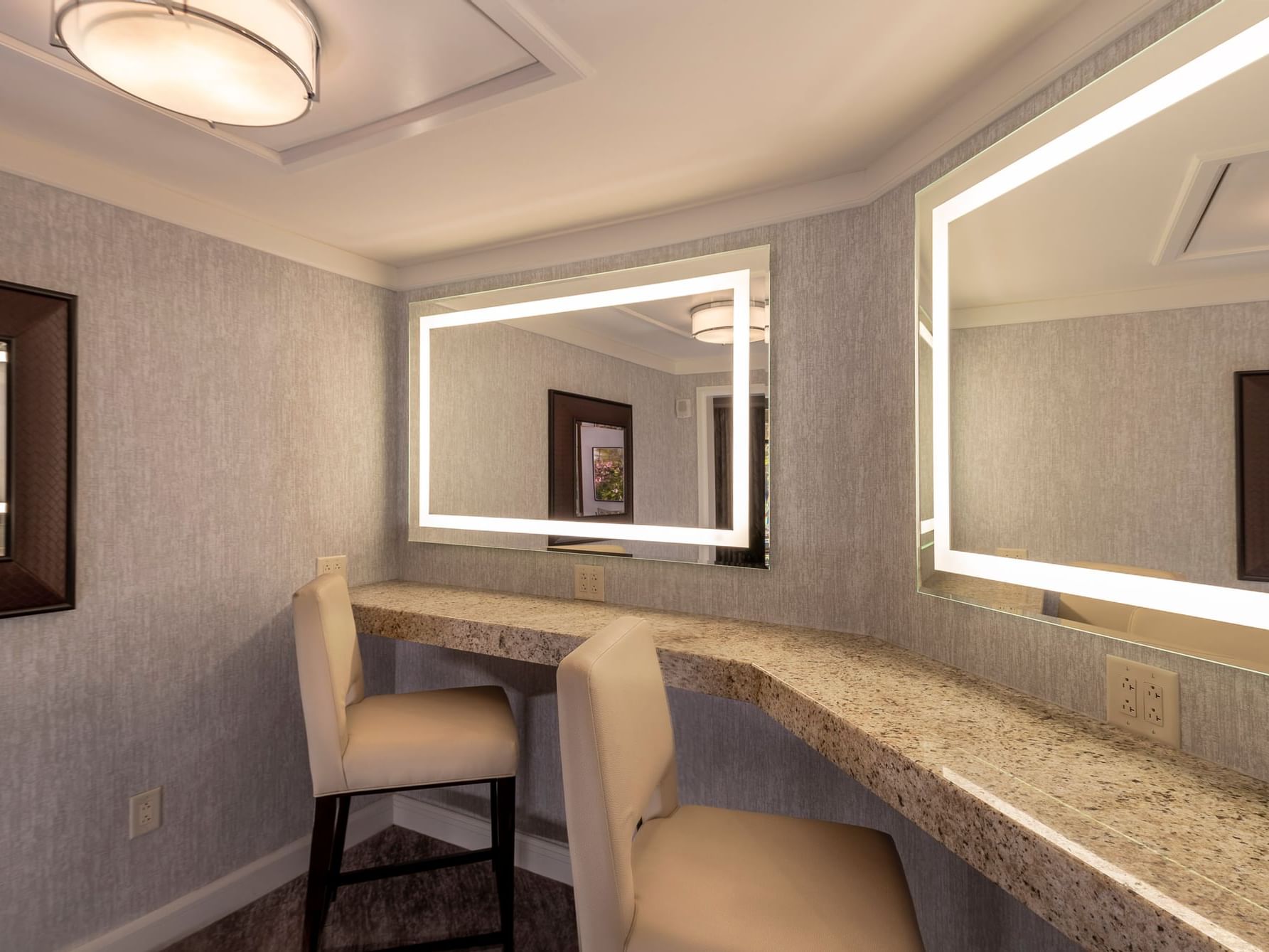 Powder area with illuminated mirrors in Signature Spa Level Suite at The Umstead Hotel and Spa
