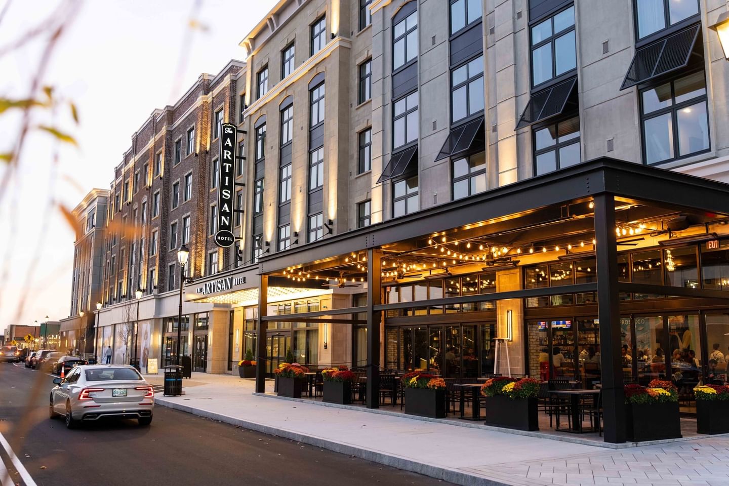 Exterior view of the hotel & dining area at The Artisan Hotel at Tuscan Village