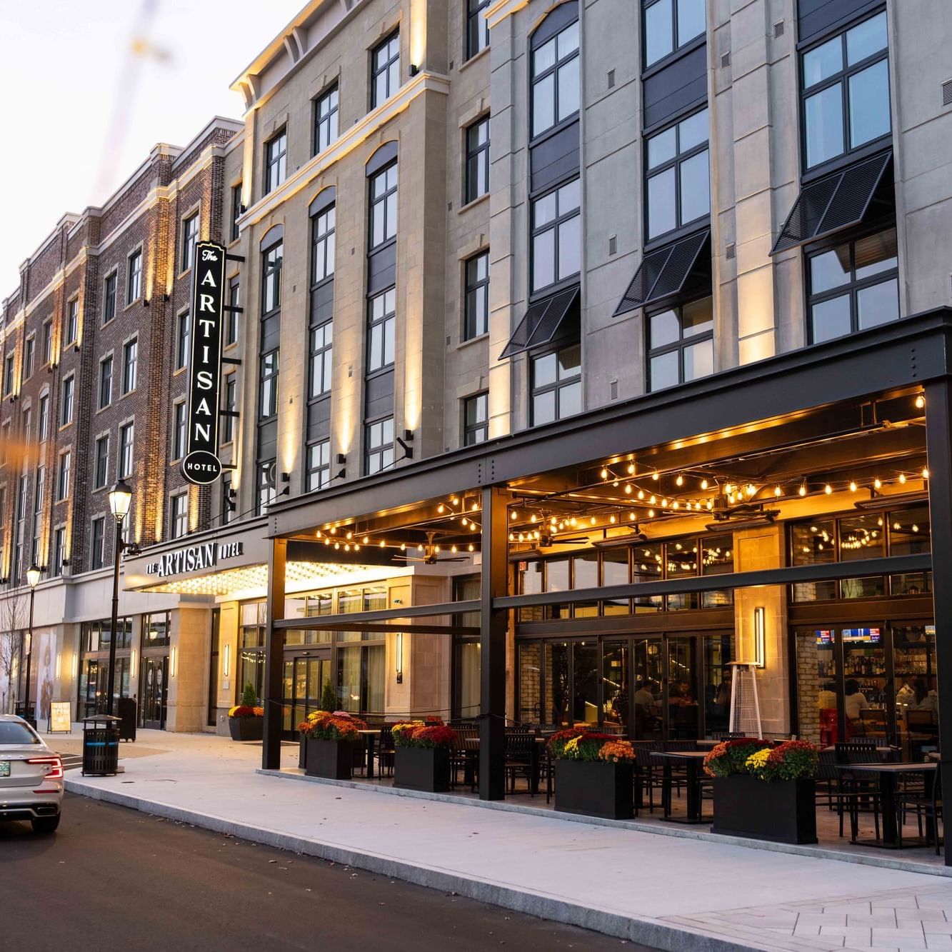 Exterior view of the hotel & dining area at The Artisan Hotel at Tuscan Village