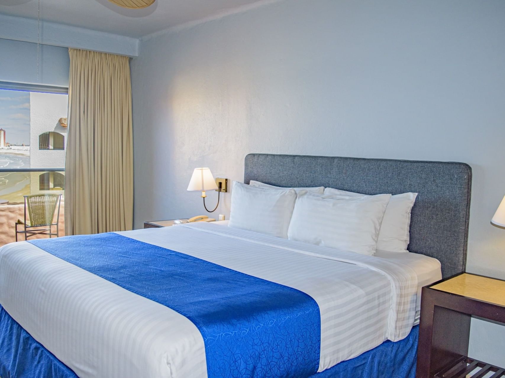 A king bed in Deluxe Single Room at Peñasco del Sol Hotel