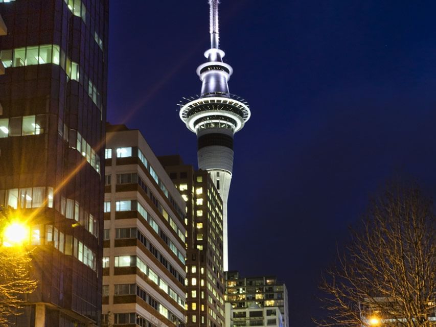 Low-angle view of Sky Tower near Hotel Grand Chancellor