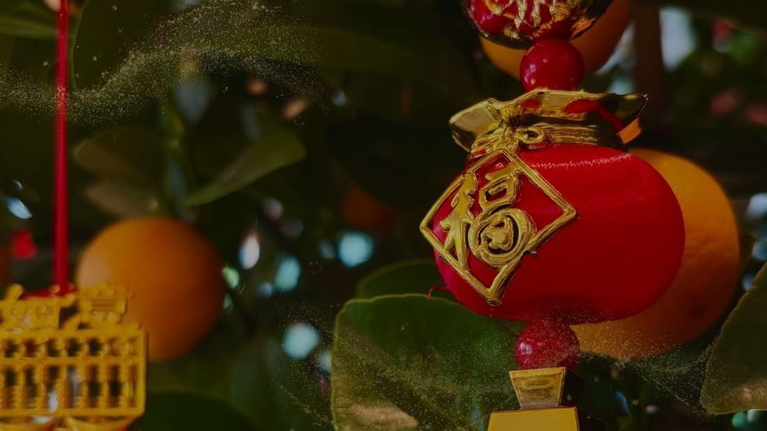 Traditional Chinese New Year ornaments with oranges and gold decorations for A Season of Harmony.