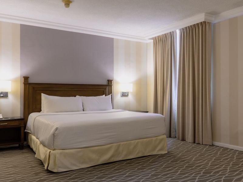 Large bed in the Deluxe King Room at Gamma Hotels