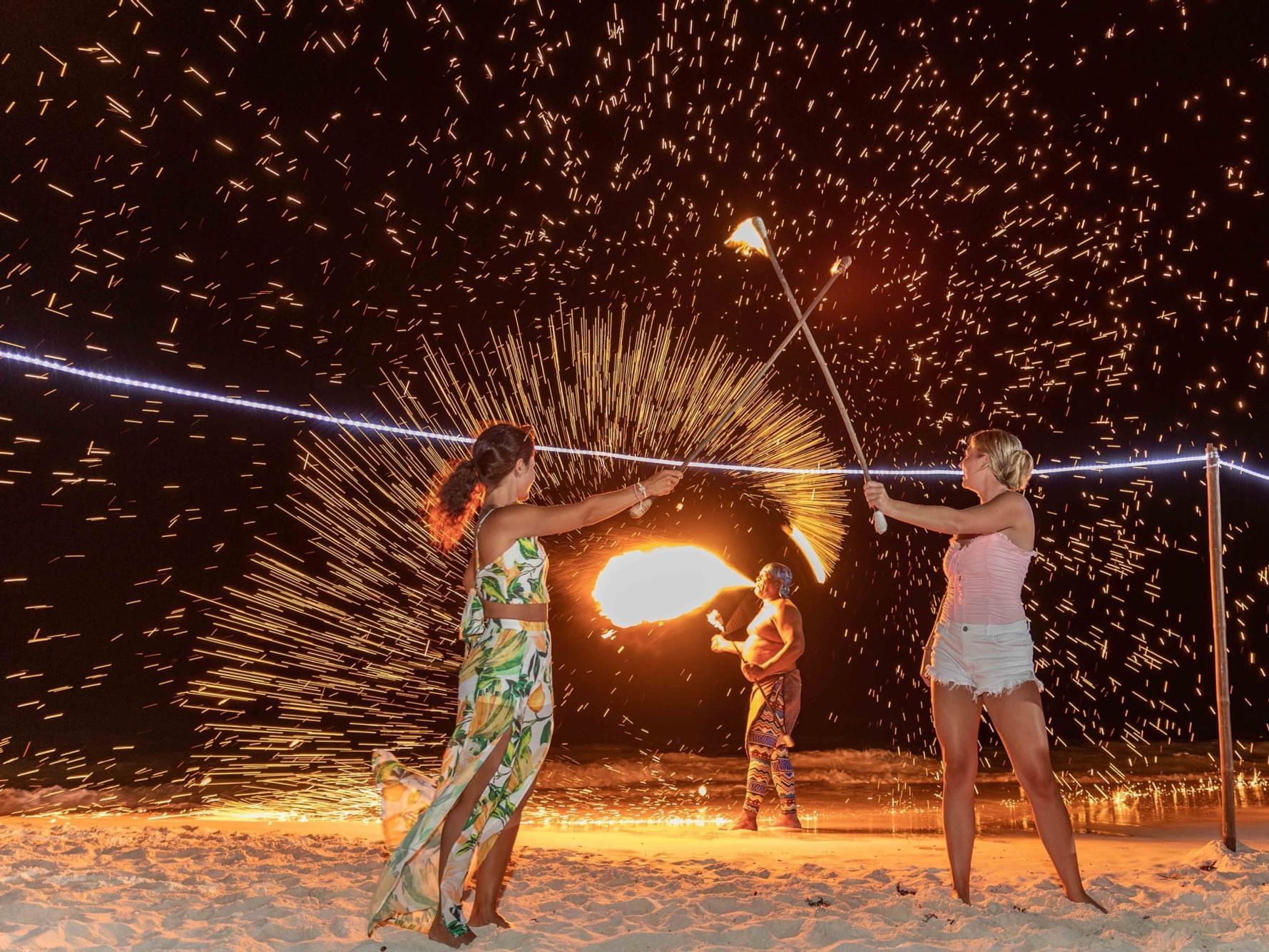 Woman with firecrackers in Beach BBQ, The Somerset on Grace Bay