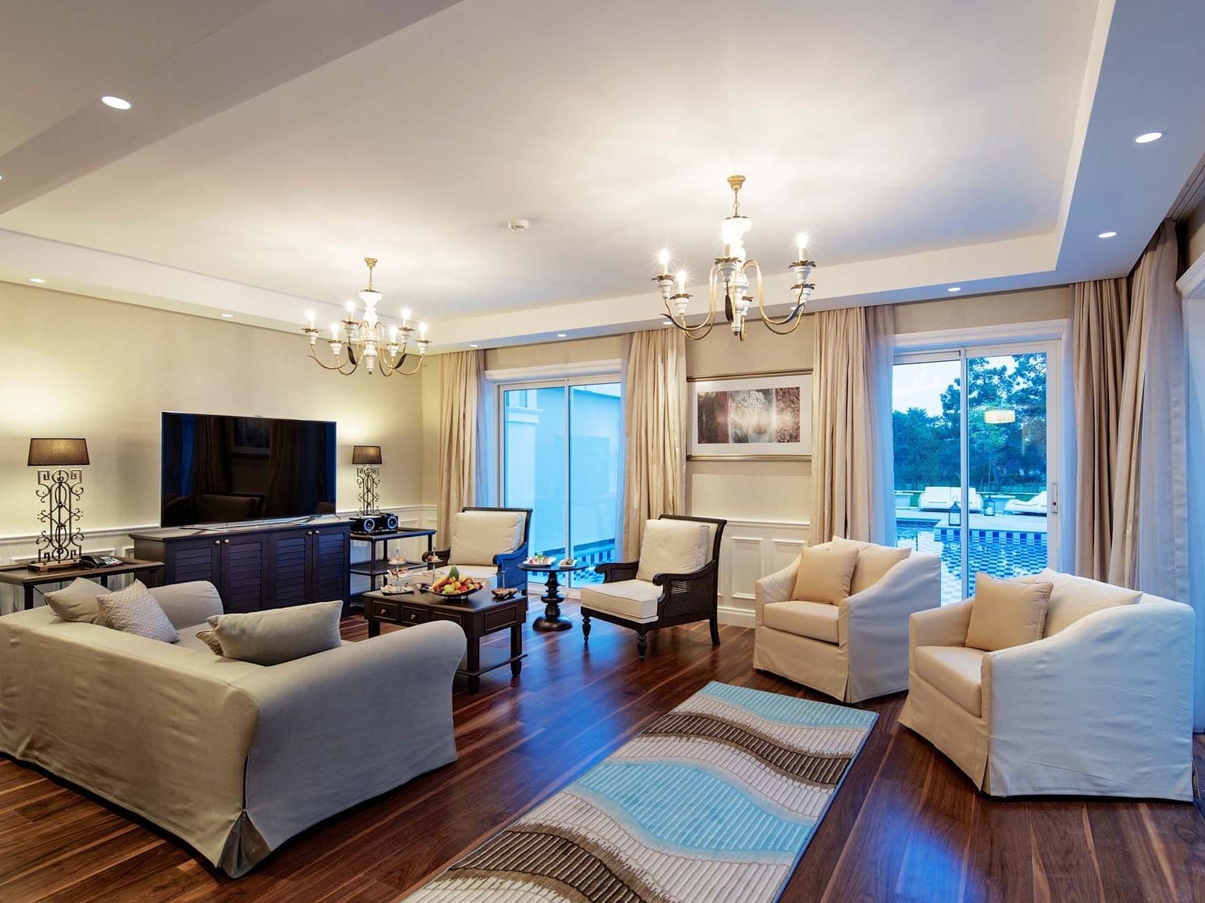 TV lounge area in Superior Villa with wooden floors at Titanic Deluxe Golf Belek