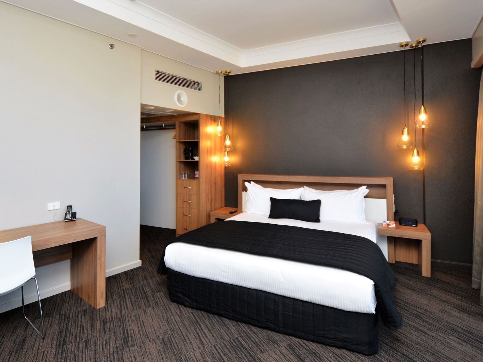 Work desk by king bed in Executive Suite at Grand Chancellor Townsville