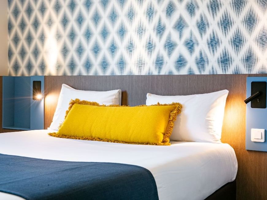 Kings bed in standard double room at The Originals Hotels