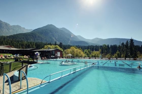 Scenic view of a large pool with mountains in the background at Harrison Lake Hotel