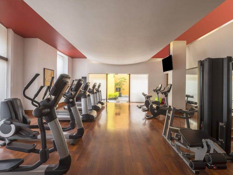 Gym with exercise machines at La Colección Resorts