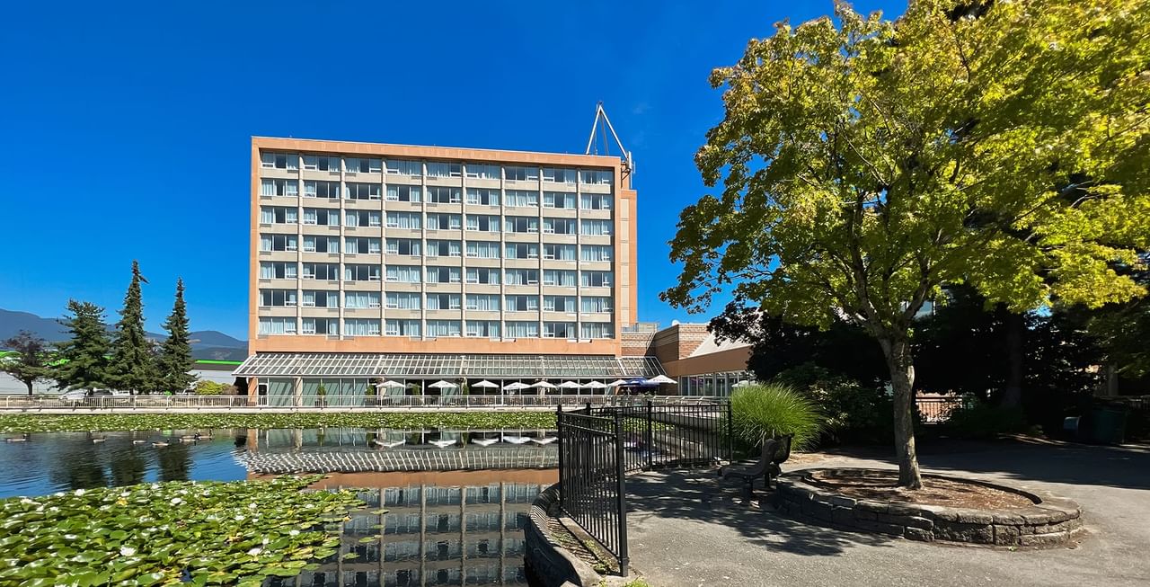 Exterior of Coast Chilliwack Hotel by APA with pond and greenery