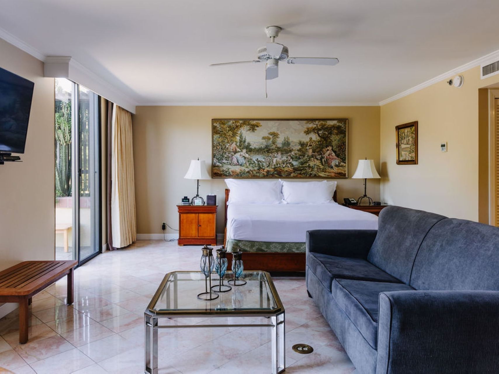 Large bed & comfy sofa in a Suite at Dinah's Garden Hotel