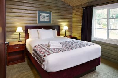 Guest bed with lamps on nightstands.