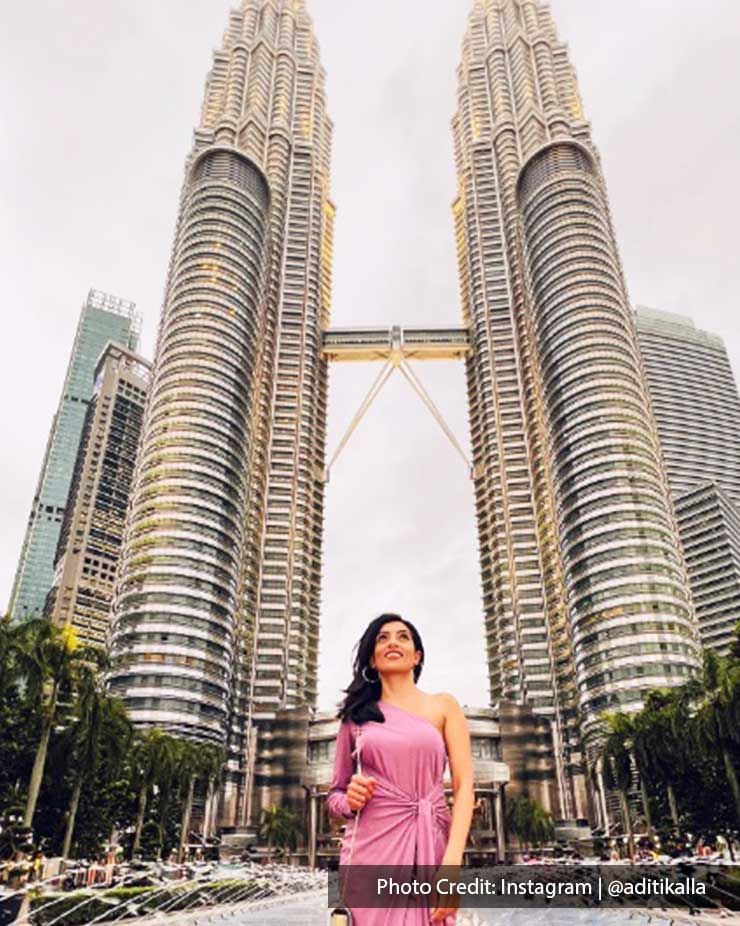 Lady posing in front of The Petronas Twin Towers, famous skyscraper buildings near Imperial Lexis Kuala Lumpur