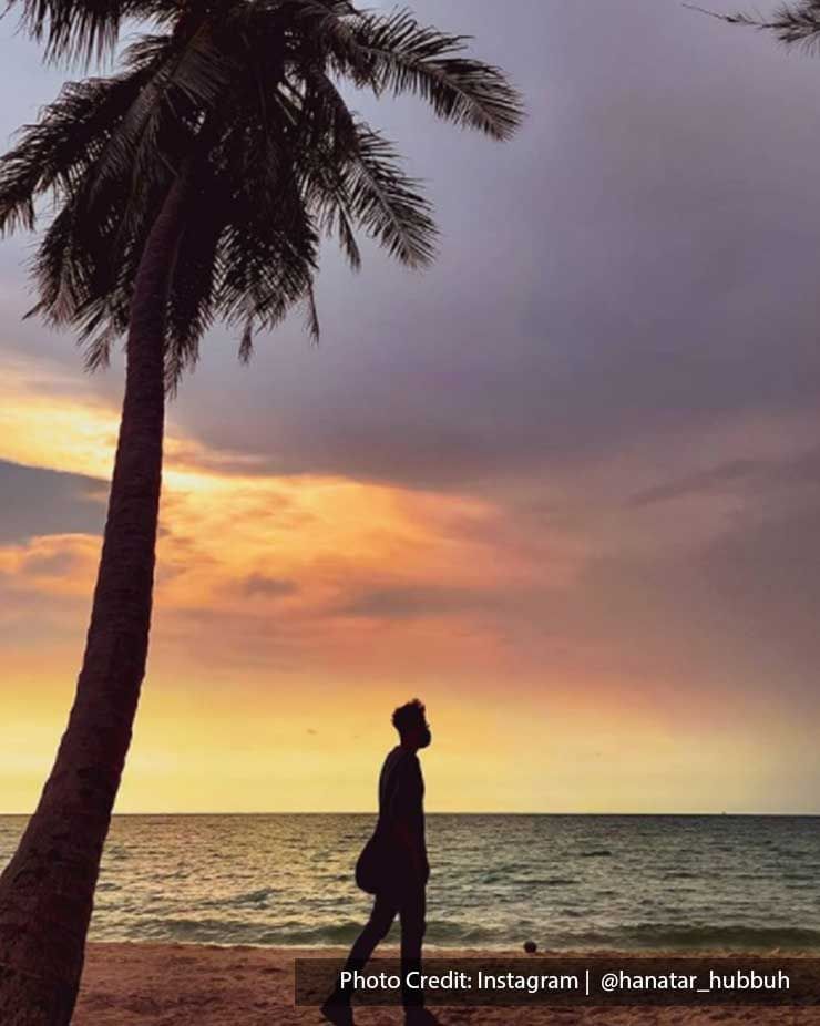 Man walking on beach during sunset in Port Dickson - Lexis Hibiscus