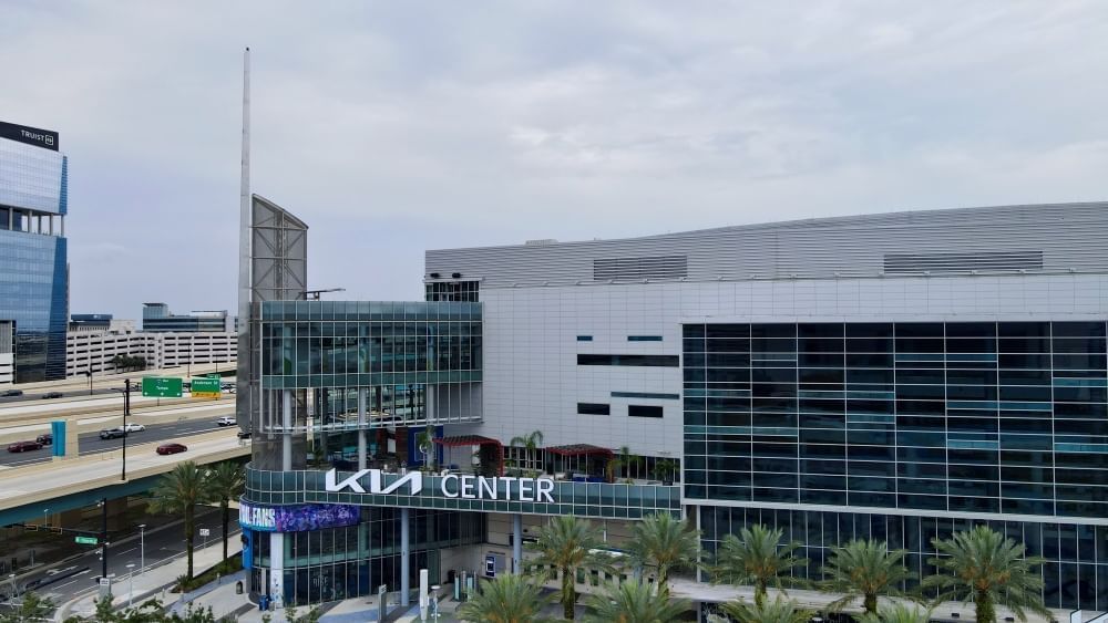 The Kia Center in Downtown Orlando, a large building with walls of windows. 