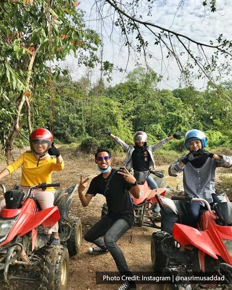 a group of friends taking pics while riding the ATV